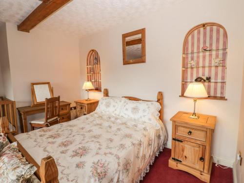 a bedroom with a bed and a table and chairs at The Stable in Craven Arms