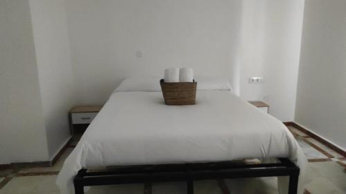 a bedroom with a bed with two candles on it at Convenient Rooms - Ferry, Train & Bus Station - in Algeciras