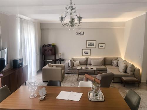 a living room with a couch and a table at API Projects Nafplio - Family Superior Apartment in Nafplio