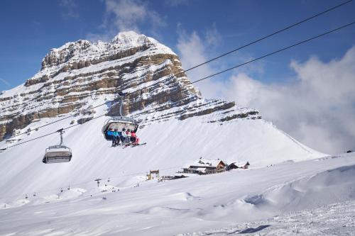 people on a ski lift on a snow covered mountain at Casa al Sole Apt. 2 in Pinzolo