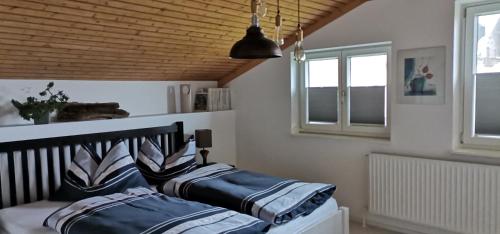 two beds in a room with two windows at Haus Jastrinsky in Dorfgastein