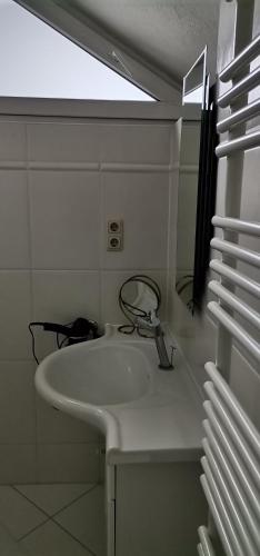 a white bathroom with a sink and a mirror at Haus Jastrinsky in Dorfgastein