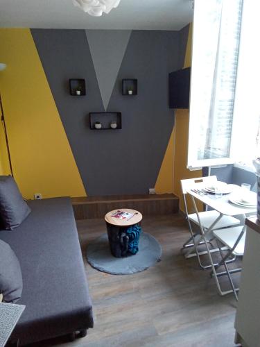 uma sala de estar com um sofá e uma mesa em Cosy em Marselha