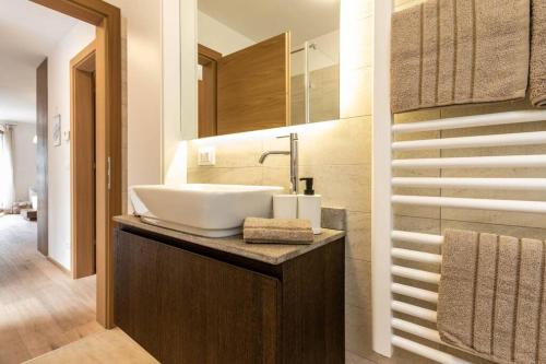 a bathroom with a sink on a counter with a mirror at Casa Ami in Sesto