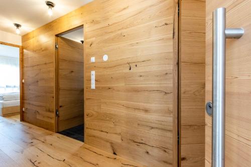 a wooden wall in a bathroom with a wooden door at Casa Erika in San Lorenzo di Sebato