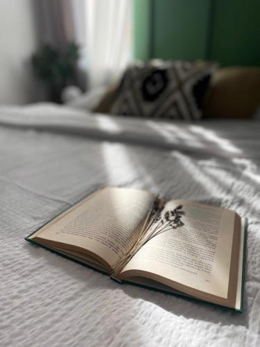 an open book laying on a bed at Gólyafészek Vendégház in Egerszalók