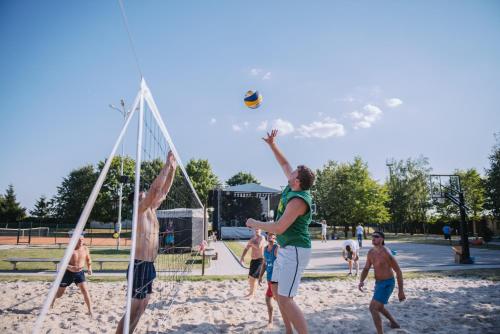 a group of people playing volley ball on a beach at Gargždų pramogos in Gargždai