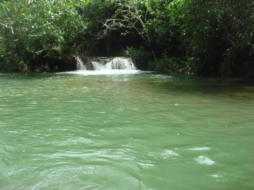 a small waterfall in the middle of a river at Sítio Chalako, casa exclusiva às margens do Rio Mimoso in Bonito