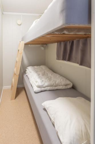 two bunk beds in a small room at Aurora River Camp Glass igloos & cabins in Kiruna
