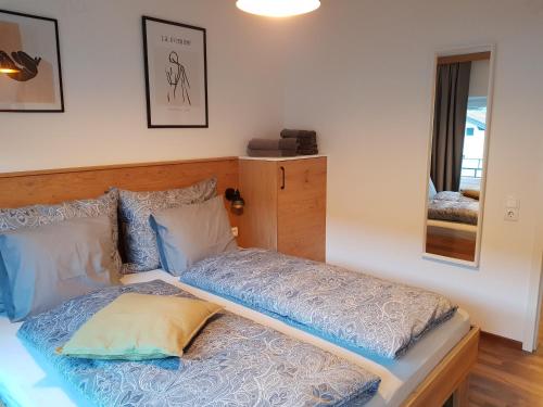 a bed with two pillows on it in a room at Exklusiv Apartment Sonnenalp in Niederau