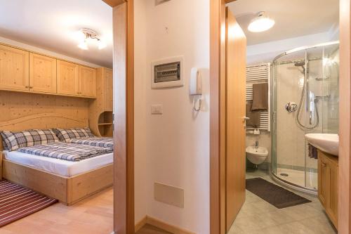 Schlafzimmer mit einem Bett, einer Dusche und einem Waschbecken in der Unterkunft Casa Relax in Oberrasen