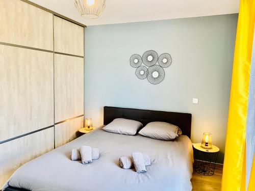 a bedroom with a bed with two pillows on it at La Contemporaine in Brax