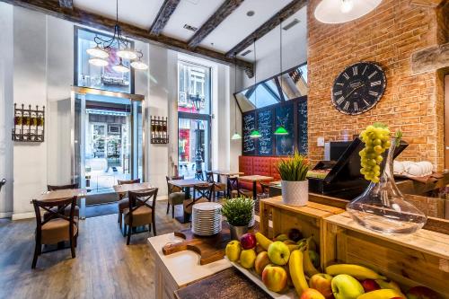 a restaurant with a bunch of fruits on a table at Estilo Fashion Hotel Budapest in Budapest