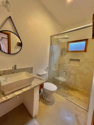 a bathroom with a sink and a toilet and a shower at Villa Milagre in Trancoso