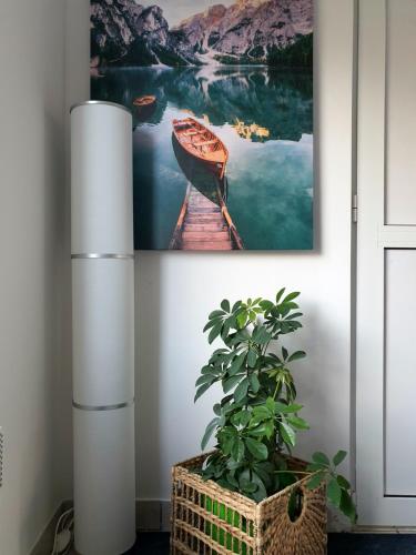 a painting of a boat on a dock next to a plant at Negotin Centar Apartment with Parking in Negotin