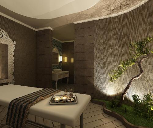 a bedroom with a bed and a bathtub with a tree mural at Sueno Hotels Deluxe Belek in Belek