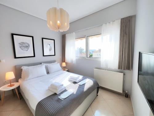 a bedroom with a bed and a tv in it at Nefelis C2 by Verde Apartments in Athens
