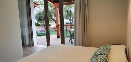 a bedroom with a bed and a view of a patio at Artmonia in Castalla
