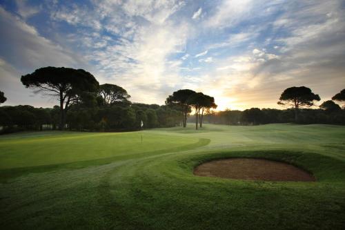 a golf course with a hole in the middle of a green at Sueno Hotels Deluxe Belek in Belek