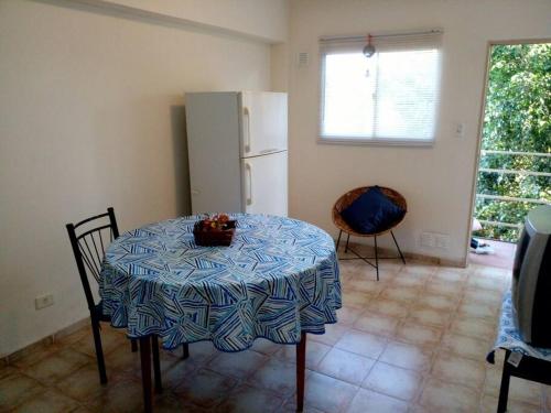 a kitchen with a table and a refrigerator at Buenos Aires Tango Apartment near Golf in San Antonio de Padua