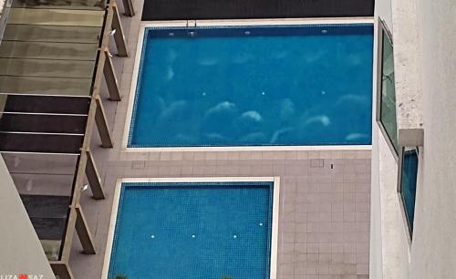 an overhead view of a swimming pool in a building at SAFIYYA HOMES MERU RAYA - WIFI/NETFLIX in Ipoh