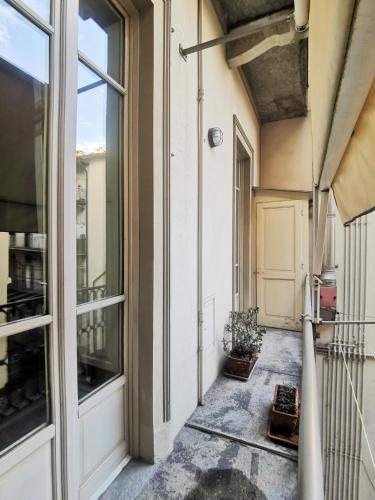 an empty balcony with a door and a plant at LA QUALITA' AL QUADRATO in Turin