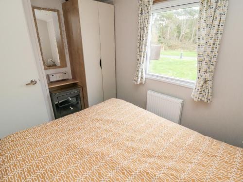 a bedroom with a bed and a window at Pines 30 in Scarborough
