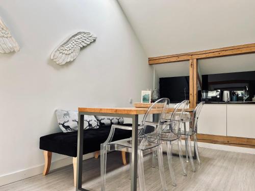 a dining room with a table and chairs and a couch at Apartamenty Rajcza in Rajcza
