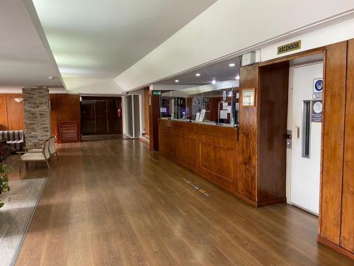 an empty room with a wooden floor and wooden walls at Hotel Rayentray Tehuelche in Esquel