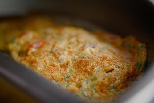 a close up of a pizza in a pan at Premier Inn Grand Gulberg Lahore in Lahore
