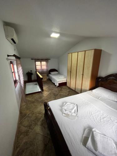 a bedroom with two beds with white sheets at Puerta Apartments in Kotor