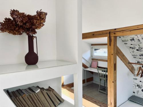 a room with a staircase and a vase on a shelf at Apartamenty Rajcza in Rajcza