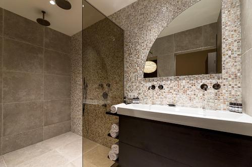 a bathroom with a sink and a mirror at Hotel de Leijhof Oisterwijk in Oisterwijk