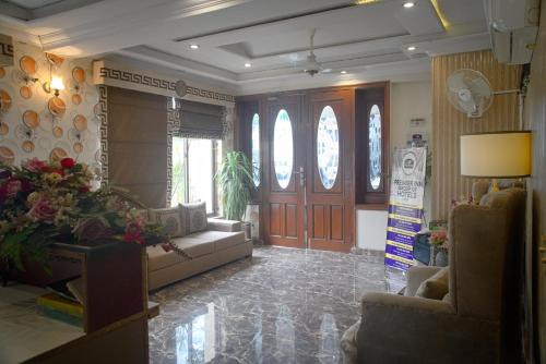 a living room with a couch and a table at Premier Inn Grand Gulberg Lahore in Lahore