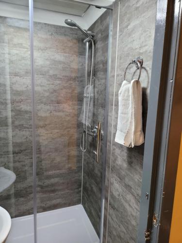 a bathroom with a shower with a glass door at The Residence - NO 8 in Edinburgh
