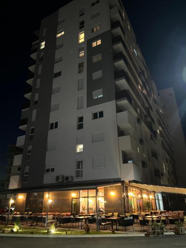 a tall building with tables in front of it at night at 7th Sky in Doboj