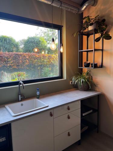 a kitchen with a sink and a window at Fun-Size holiday home Zwolle in Zwolle