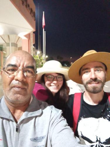 two men and a woman wearing hats posing for a picture at Airport Agadir Guest House in Agadir