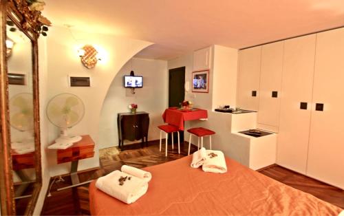 Habitación con cama, mesa roja y taburete. en Appartamento Girasole, en Florencia