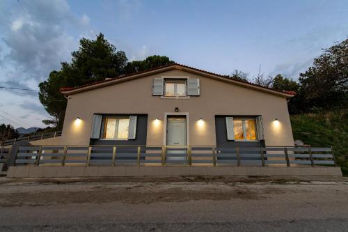 a small house with a fence in front of it at Summit Guest House in Kalavrita