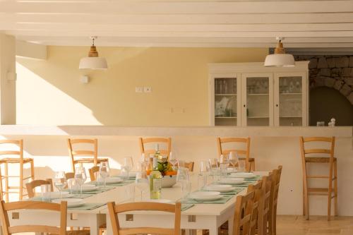 a dining room with a long table and chairs at Trulli Casalina in Cisternino