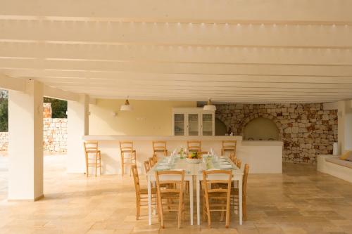 a kitchen and dining room with a table and chairs at Trulli Casalina in Cisternino