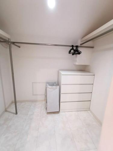 a white garage with a refrigerator in a room at Bell house in Tokyo