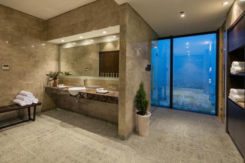a bathroom with a sink and a mirror at Luxury Beach Condo 5-star, Rooftop pool in Da Nang