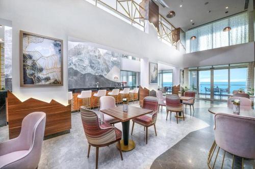 a restaurant with tables and chairs in a room at Tolip Resort El Galala Hills in Ain Sokhna