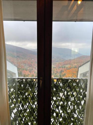 a window with a view of the fall foliage at OpenSpace Vista Panoramica in Abetone