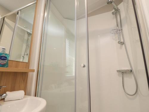 a shower with a glass door in a bathroom at 32 Bayview in Morecambe