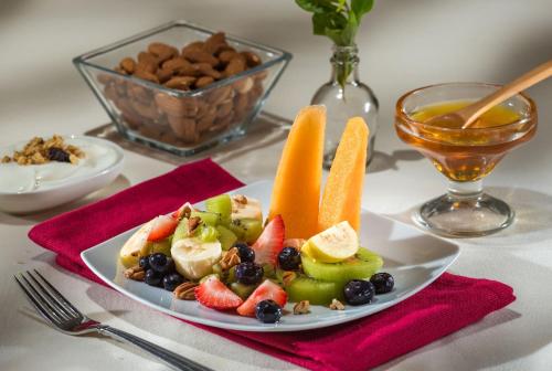 a plate of fruit and vegetables on a table at Safi Royal Luxury Metropolitan in Monterrey