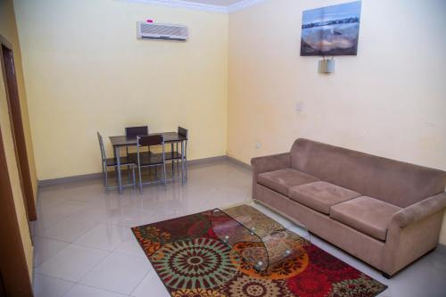 a living room with a couch and a table at Airside Hotel in Accra
