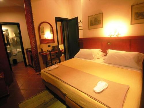 a bedroom with a large bed and a bathroom at Hotel Toledo in Naples